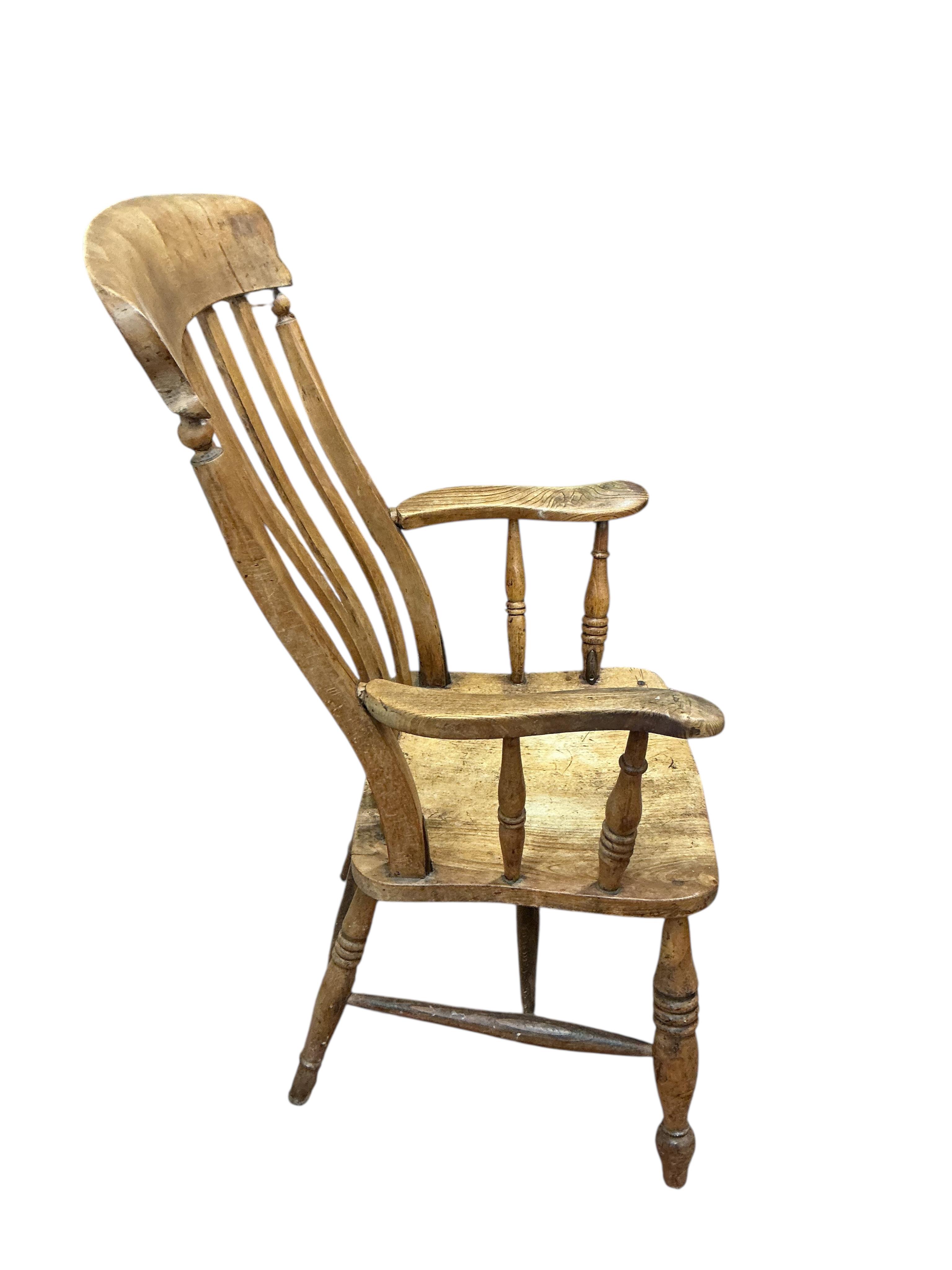 A near pair of Victorian elm and beech Windsor lathe back armchairs